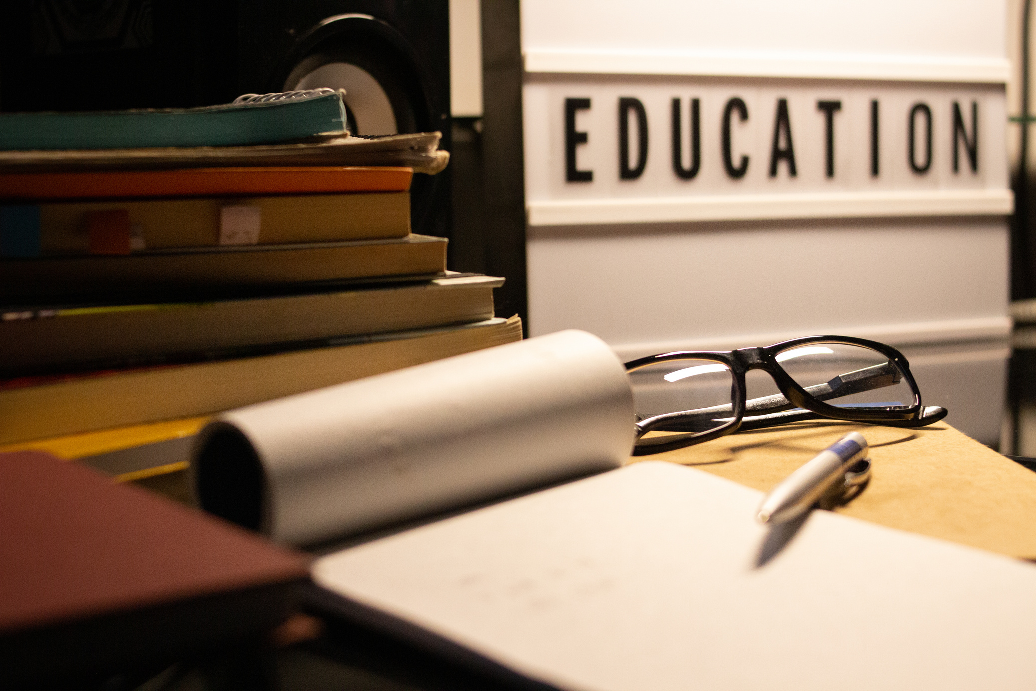 Books, glasses, pencil and education posters